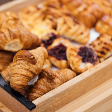Freshly baked croissants and pastries served at hotel breakfast buffet, offering a delightful start to your stay.